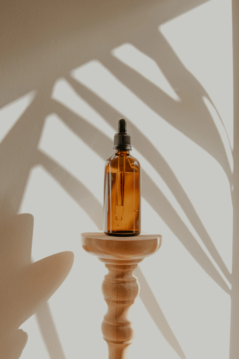 Bath oil in amber glass bottle with dried flowers